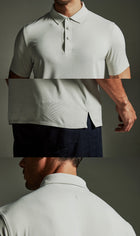 The TECHTEE grey polo shirt worn by a person on a dark background