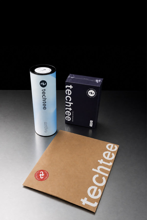 Techtee product gift boxes arranged on a dark surface.