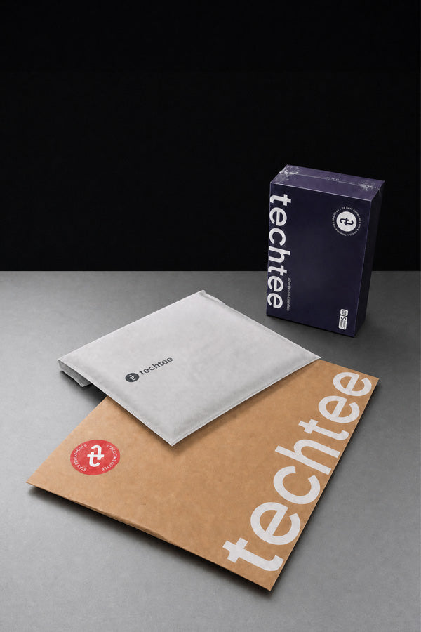 Packaging with 'techtee' branding on a gray surface