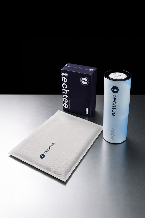 TechTee products including a box, non-woven pouch, and cylindrical container on a reflective surface with a black background.