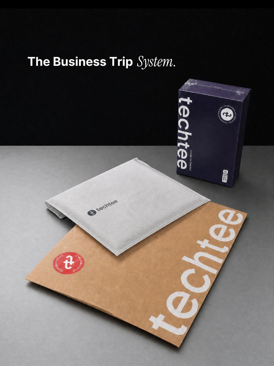 techtee branded items including a box, non-woven pouch, and packaging bag on a gray surface.
