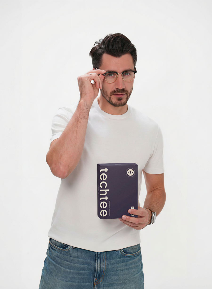 Man wearing glasses and holding a 'techtee' product against a white background